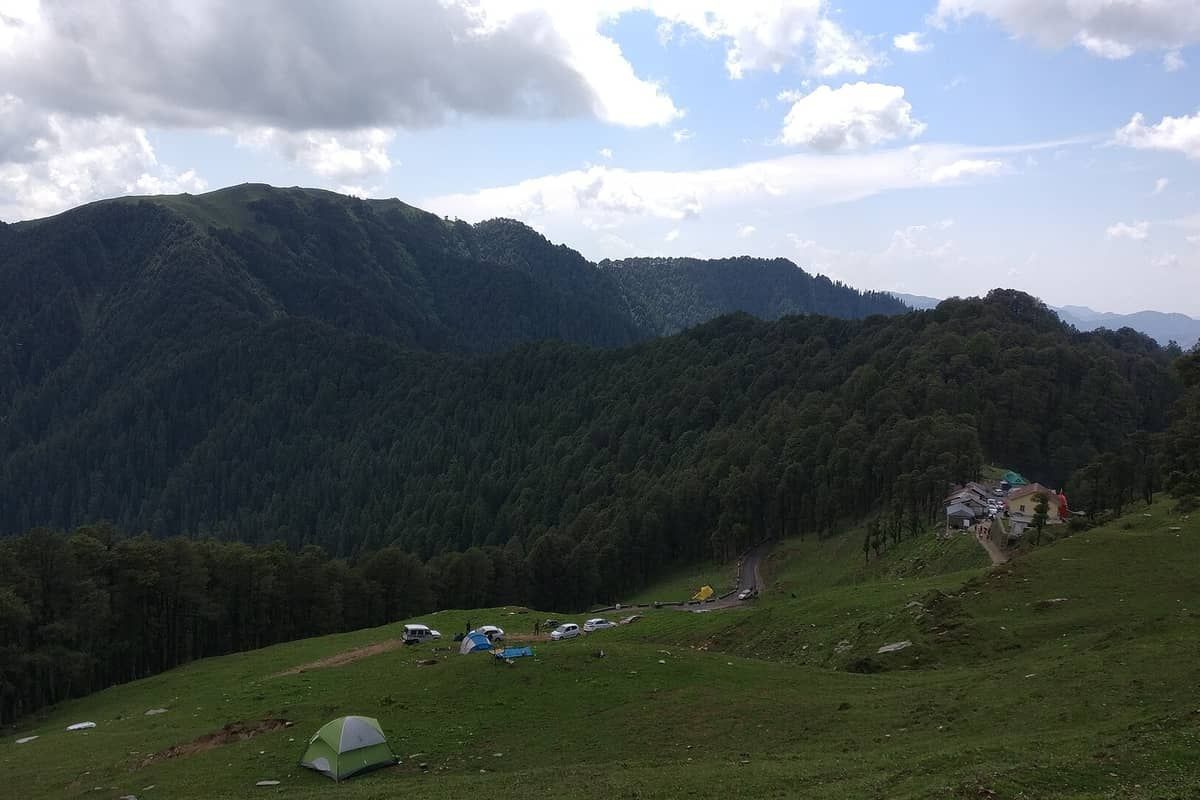Green forested slopes and meadow at Jalori Pass in Kullu district