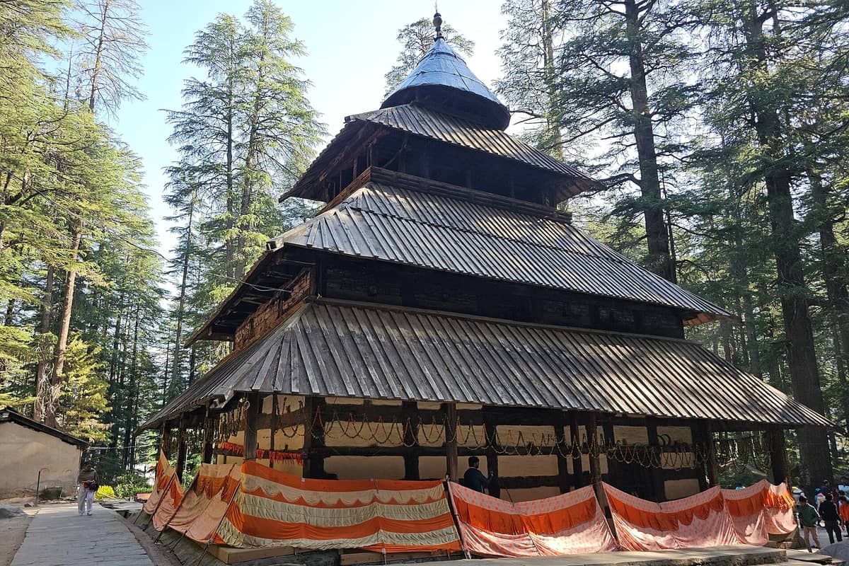 Pagoda-roofed wooden Hadimba Devi Temple among tall deodar trees in Manali